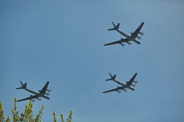 Three Tu-95 aircraft fly over park during parade