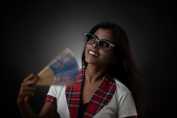Portrait of an Asian/Indian/African brunette dark skinned young girl in sexy school uniform and...