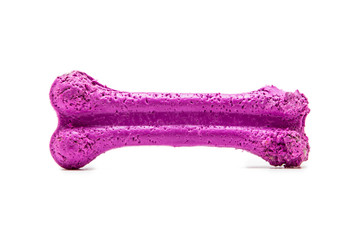 Dog toy, rubber bone, on the table isolated on white