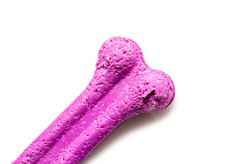 Dog toy, rubber bone, on the table isolated on white