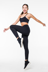 Full length picture of jumping fitness woman over gray background