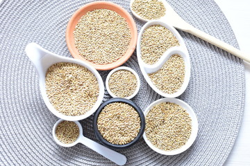 birdseed seeds, food for birds, displayed in containers on cloth bottom