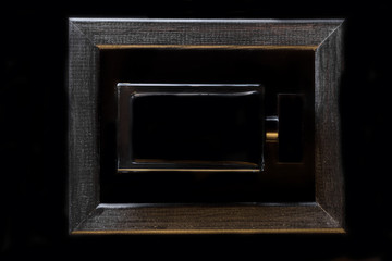 Obraz premium Minimalism on a black background .Black frame and black perfume bottle