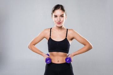 Fototapeta na wymiar Athletic fitness girl with dumbbells on a white background