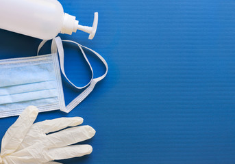 Medical mask, glove and disinfectant for corona virus on blue background