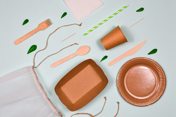 Zero waste, environmentally friendly, disposable, cardboard, paper utensils on a blue background. View from the top.