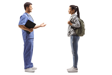 Fototapeta premium Male doctor taking to a female student