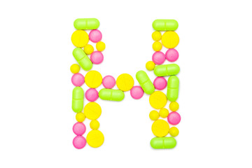 Alphabet of tablets and pills isolated on white