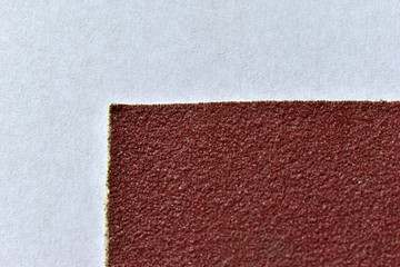Red rough surface of sandpaper close up