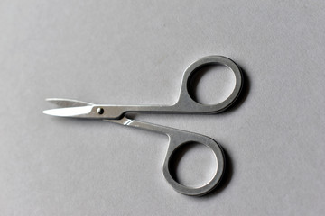 Manicure steel scissors shiny on a white background