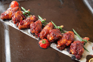  Grilled baked chicken wings with hot chili pepper and soy sauce.