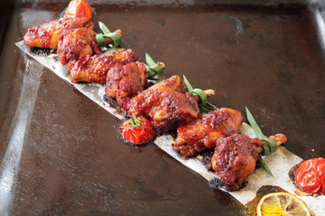  Grilled baked chicken wings with hot chili pepper and soy sauce.