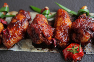  Grilled baked chicken wings with hot chili pepper and soy sauce.