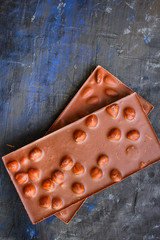chocolate bar hazelnuts and almonds (delicious sweet dessert snack) menu concept. background. top view. copy space for text