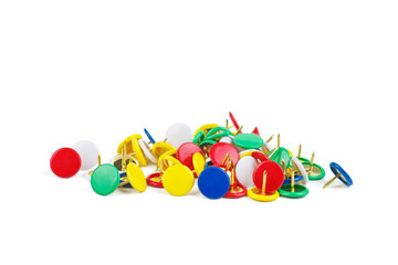 Pile of colorful thumbtacks on white background.