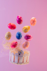 Wooden basket with floating painted easter eggs