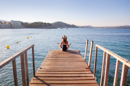 yoga woman on pier