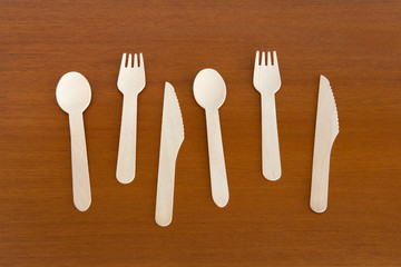 wooden spoon, fork and knife on wooden table