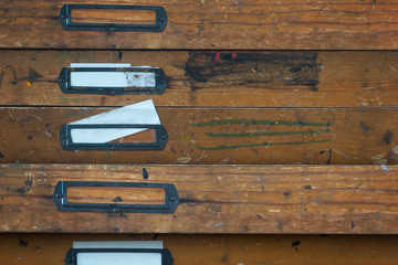 Archive with vintage wooden drawers and metal label holders, one drawer slightly open