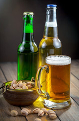 Light beer in a glass on a table in composition with accessories on an old background