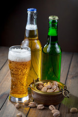 Light beer in a glass, on an old background.