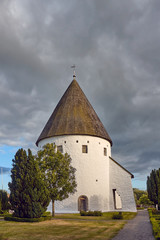 Fototapeta premium St Olaf's Church (Sankt Ols Kirke) or Olsker Church - 12th-century round church which is the highest of Bornholm's four round churches, located in the village of Olsker, Bornholm island, Denmark