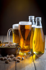 Light beer in a glass on a table in composition with accessories on an old background
