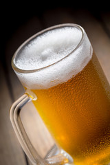 Light beer in a glass on a table in composition with accessories on an old background