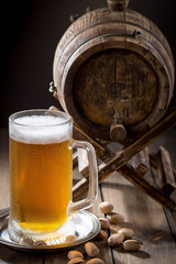Light beer in a glass on a table in composition with accessories on an old background