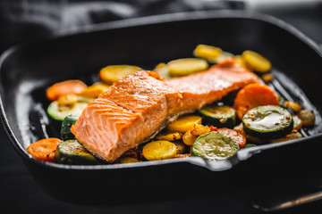 Grilled salmon with vegetables on pan