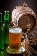 Light beer in a glass on a table in composition with accessories on an old background