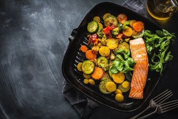 Grilled salmon with vegetables on pan
