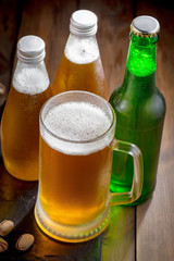 Light beer in a glass on a table in composition with accessories on an old background