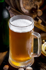 Light beer in a glass on a table in composition with accessories on an old background