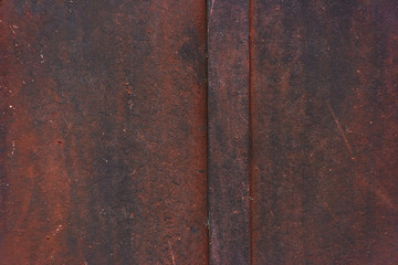 The dark metal surface is covered with corrosion