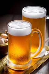 Light beer in a glass, on an old background.