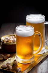 Light beer in a glass, on an old background. 