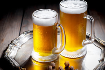 Light beer in a glass on a table in composition with accessories on an old background