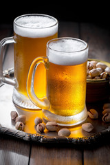 Light beer in a glass on a table in composition with accessories on an old background