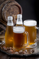 Light beer in a glass on a table in composition with accessories on an old background