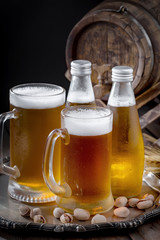 Light frothing beer in a glass, on an old background.