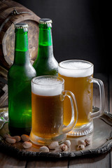 Light beer in a glass on a table in composition with accessories on an old background