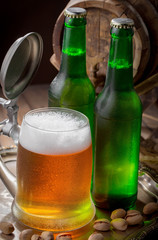 Light beer in a glass on a table in composition with accessories on an old background