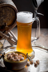 Light beer in a glass on a table in composition with accessories on an old background