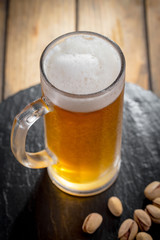 Light beer in a glass on a table in composition with accessories on an old background