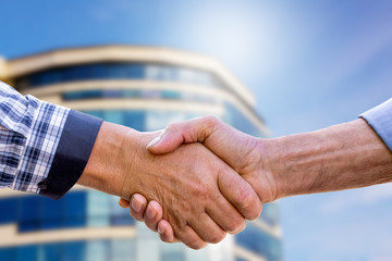 Businessmen shaking hands when buying a home. Handshake of men on modern home background_