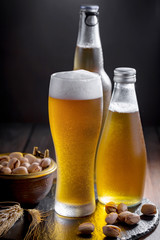 Light beer in a glass, on an old background. 