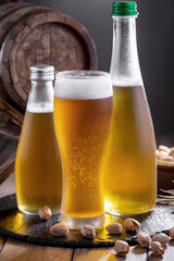 Light beer in a glass on a table in composition with accessories on an old background