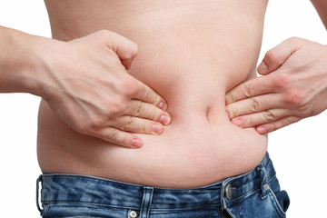 Naklejka premium male hand presses the excess fat on your stomach