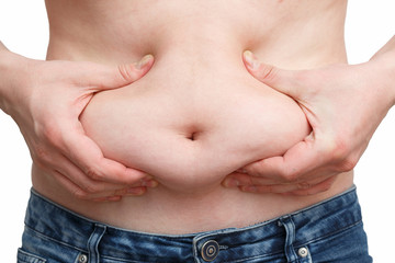 male hand presses the excess fat on your stomach